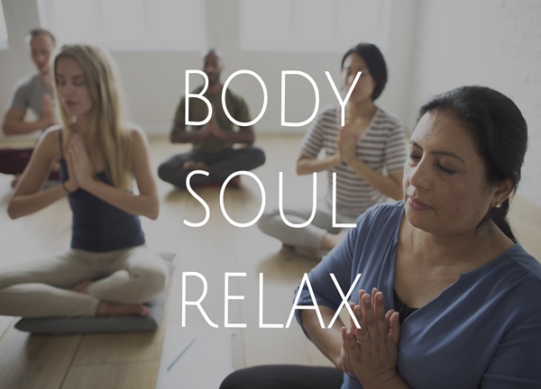 group of people training in yoga class for body soul and mind re